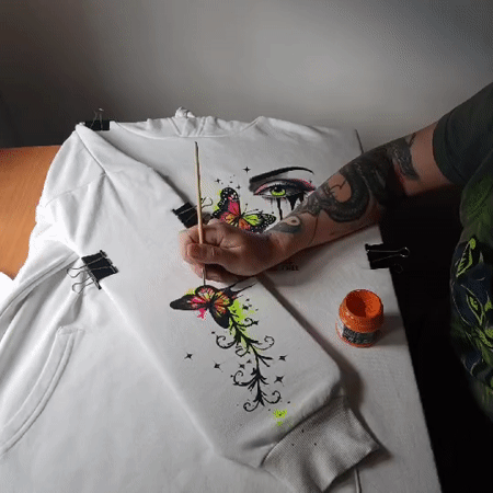 Hand-painted hoodie and wildflowers on a Riga afternoon