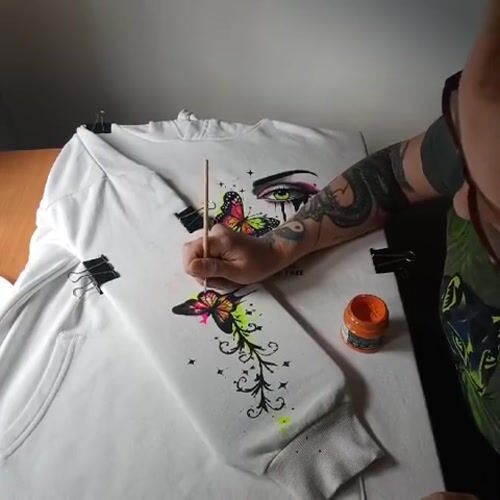 Hand-painted hoodie and wildflowers on a Riga afternoon