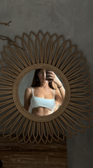 Mirror selfies in a rattan-decorated Bali room
