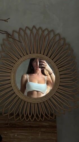 Mirror selfies in a rattan-decorated Bali room