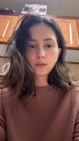 Woman expresses tiredness in kitchen in Abu Dhabi