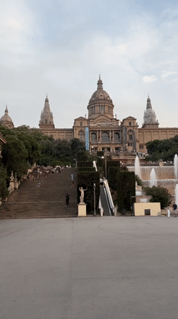 Evening crowd gathers at Barcelona museum fountains for photos, performances