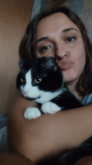 Woman poses with cat during late-night photo session