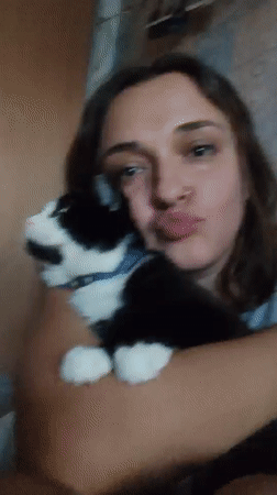 Woman poses with cat during late-night photo session