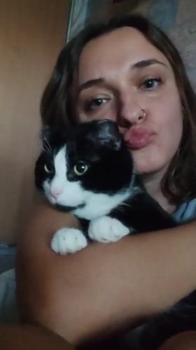Woman poses with cat during late-night photo session