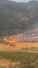 Open fire burning near Krichim with hills in the background
