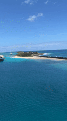 Aerial footage captures coastal port with boats and cargo operations