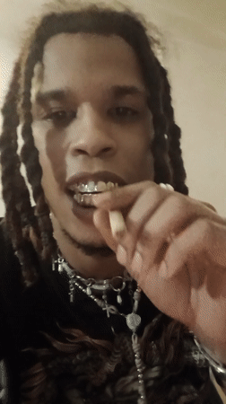 Person smoking joint near bottled liquids in Paris