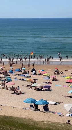 Biarritz beach in full summer swing, sun and surf.