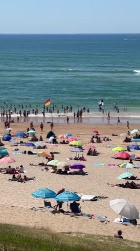 Biarritz beach in full summer swing, sun and surf.
