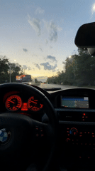 BMW dashboard view captured during dusk drive in Sofia