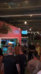 Woman addresses cheering crowd at São Paulo bar Friday night