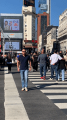 Pedestrians cross street in Buenos Aires during evening hours
