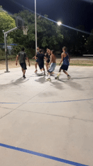 Late-night pickup basketball on an outdoor court in Tarragona
