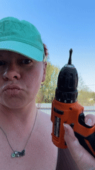 Woman tests cordless drill in Chaikovsky, Russia