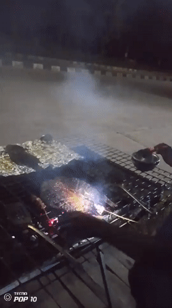 Nighttime street barbecue and market activity captured by witnesses