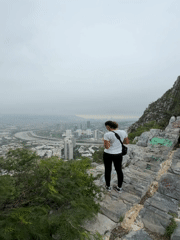 Woman views Santa Catarina cityscape from mountain overlook