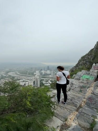 Woman views Santa Catarina cityscape from mountain overlook