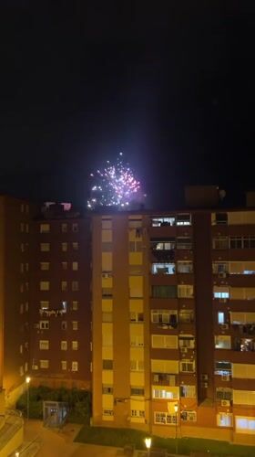 Fireworks light up night sky over Badalona apartment building
