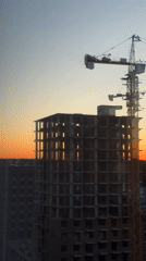 Woman documents construction site at sunset in Izhevsk