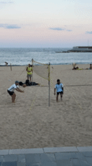 Barcelona beachgoers enjoy evening activities at Port Olímpic waterfront
