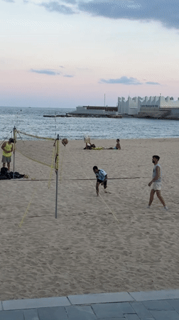 Barcelona beachgoers enjoy evening activities at Port Olímpic waterfront
