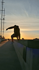 Parkour performer observed at marina during sunset hours
