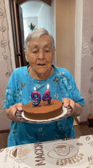 Woman celebrates 94th birthday with chocolate cake outdoors
