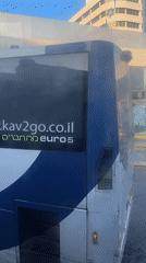 Bus parked at Netanya station on sunny day