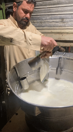 Man pours white liquid into container in Quetta