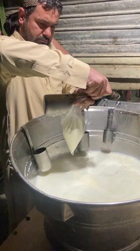 Man pours white liquid into container in Quetta