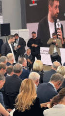 Indoor panel discussion with multilingual screen display