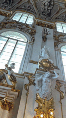 Inside a grand gilded palace or museum hall