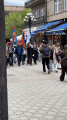 Flag-carrying demonstrators march through Gyumri streets with megaphone
