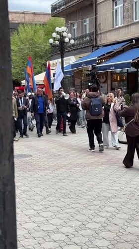Flag-carrying demonstrators march through Gyumri streets with megaphone
