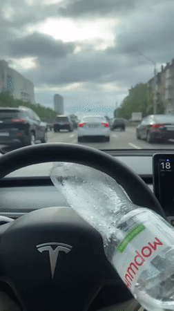 Tesla drives through Kyiv streets on overcast afternoon