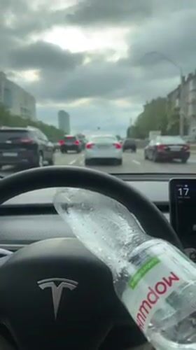 Tesla drives through Kyiv streets on overcast afternoon