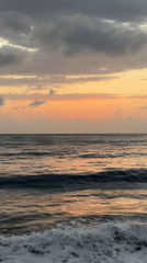 Sunset over the black pebble beach at Kubu, Bali