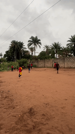 Soccer game played on dirt field in Nkpor