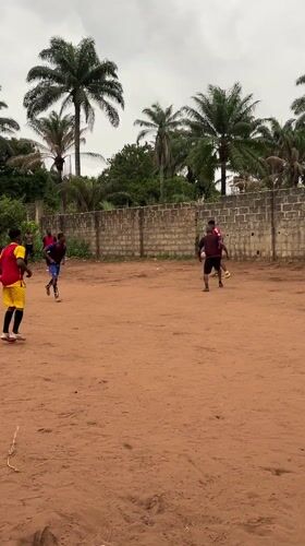 Soccer game played on dirt field in Nkpor