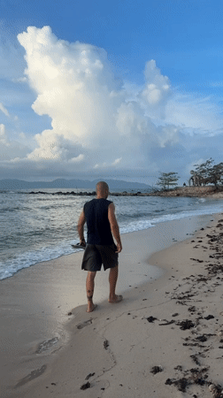 Barefoot walk toward the ocean on a Ko Samui beach