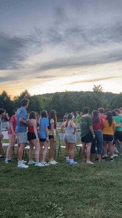 Outdoor dusk gathering on a field and pavilion, Washington Township