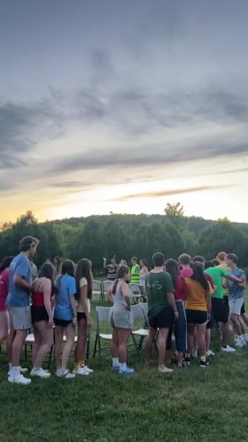 Outdoor dusk gathering on a field and pavilion, Washington Township