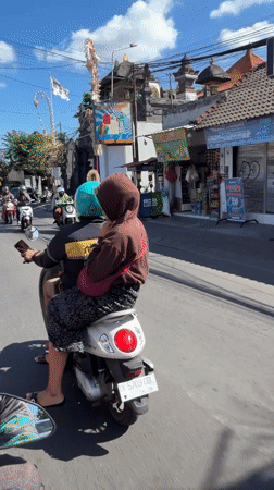 White motorcycle with two riders on a North Kuta street