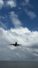 Low-flying plane approaches Batumi over a calm sea