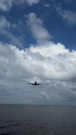 Low-flying plane approaches Batumi over a calm sea