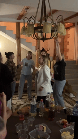 Casual indoor party with dancing and snacks in rural Russia