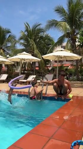 Father supervises children's pool play in Phu Thuy Ward