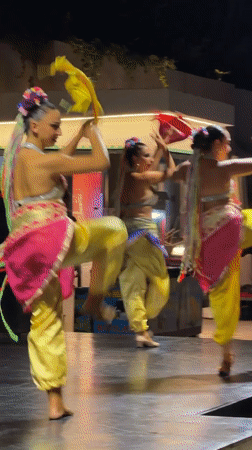 Colorful folk dance performance on a dark stage in Manavgat