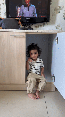 Child found sitting in cupboard under television in India